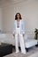 Pretty fashion beautiful woman sexy lady brunette curly hair dark tanned skin wear trend clothes knitted suit blue jacket white