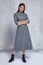 pretty fashion woman wear wool grey dress casual trend clothes collection catalogue brunette hair party style model pose