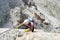 Pretty female climber in lilac shirt on a steep Via Ferrata in the italian Dolomites