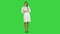 Pretty female doctor describing and advertising pills for the camera on a Green Screen, Chroma Key