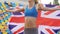 Pretty female runner winning competition, athlete holding flag of Great Britain