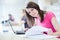 Pretty female student with laptop and books