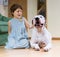 Pretty female toddler on the floor with dogo