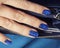 Pretty fingers, deep blue manicure close up with