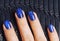 Pretty fingers, deep blue manicure close up with