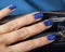 Pretty fingers, deep blue manicure close up with