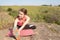 Pretty fitness girl activity with stretching exercises for legs, training outdoors, in nature on mat