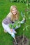 Pretty gardener woman with gardening tools