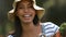 Pretty gardener woman holding box of vegetables