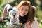 Pretty girl with bicycle and Maltese dog