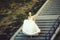 Pretty girl or cute bride walking down grey stairs