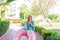 Pretty girl enjoys her walking to beach with an inflatable circle. She is listening to her favourite song on her phone, dancing,
