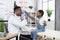 Pretty girl giving high five to african doctor after checkup