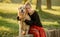 Pretty girl with golden retriever dog at nature