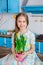 Pretty girl holding a pot of daffodil flowers in anticipation of spring and Easter