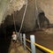 Pretty girl on path with railing in lime stone Binsari Cave on Biak Island