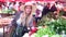 Pretty girl picking radish at the market