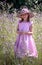 Pretty girl in pink in a pink wild flower field