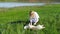 Pretty girl plays with a dog on the grass by the lake nature animals pets friend emotions happy smile dog slow motion