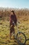 Pretty girl riding bicycle in field