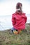 Pretty girl in shoes with rainbow color bottom sitting on the bank of sea, girls power and tolerance