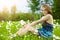 Pretty girl with snowdrop bouquet in forest