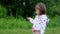 Pretty girl standing and playing with grass