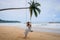 Pretty girl on swing with backgound of Nang Thong Beach in Khao lak lighthouse