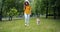 Pretty girl walking beautiful shiba inu dog in park using smartphone outdoors