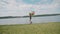 Pretty girl walks on the river bay with colourful balloons and looks on water