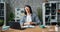 Pretty girl working with laptop in office then raising arms celebrating success