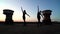 Pretty girls dancing on industrial roof at beautiful sunset