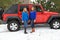 Pretty girls having fun by a Jeep