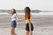 Pretty girls having fun on a natural background. Teenagers running near the lake. Female friendship concept. Copy space.