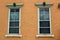 Pretty gold color exterior wall of home with ornate carvings over windows