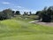 Pretty golf hole with lots of bunkers and blue sky