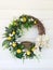 Pretty grapevine wreath on the side of a house with a Robin& x27;s bird nest in the middle