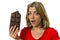 Pretty happy and excited girl holding big chocolate bar in sugar addiction temptation looking guilty skipping diet in unhealthy nu