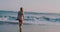 Pretty happy girl in dress relaxing on the sandy beach