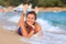 Pretty happy young woman lies on sandy sea beach. Smiling girl on sea. Summer rest on beach. Sea vacation