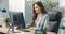 Pretty hard-working secretary of company assistant to boss manager sits at desk in office in front of computer screen