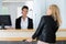 pretty hotel receptionist welcoming female guest