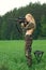 Pretty hunter girl aiming with hunting rifle in the outer wood. Carbine on the shoulder