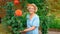 A pretty, intelligent elderly lady is engaged in gardening. Portrait of a woman gardener for a magazine about landscaping or