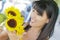 Pretty Italian Woman Looking at Sunflowers at Market