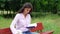 Pretty lady opens white bag and makes notes in blue notebook