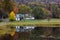 Pretty landscape with barns surrounded by colourful foliage