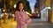 Pretty Latin woman posing for a portrait outside at night