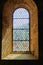 Pretty leaded stained glass window set in thick stone walls