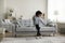 Pretty little African boy dancing in living room